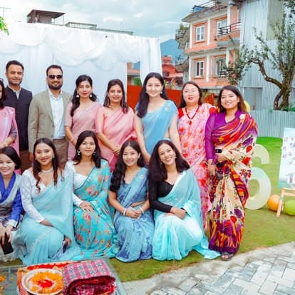 The Naman team of women in saris gathered outdoors for the 6-year anniversary