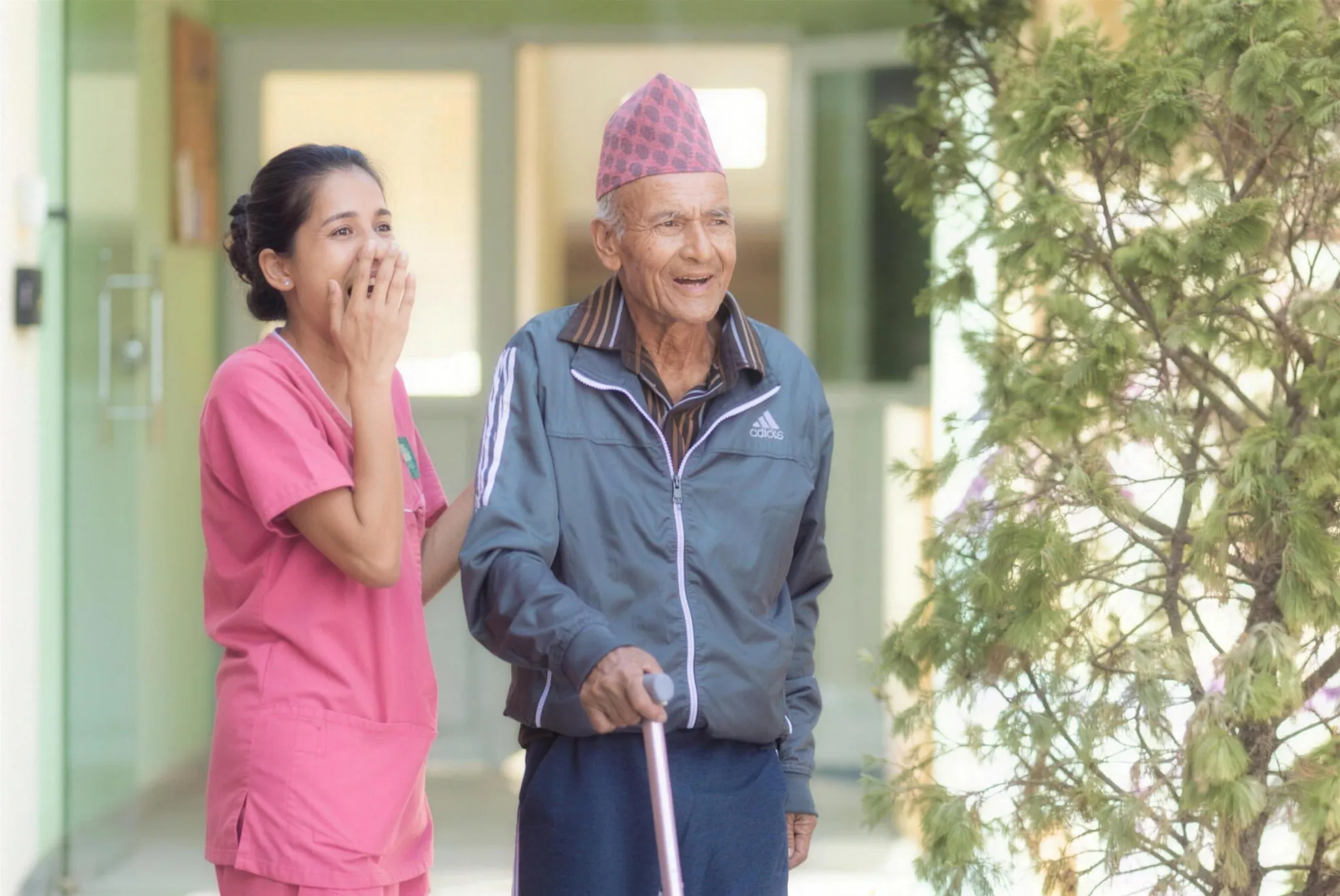A caregiver and resident by the corridor at Naman Care Home