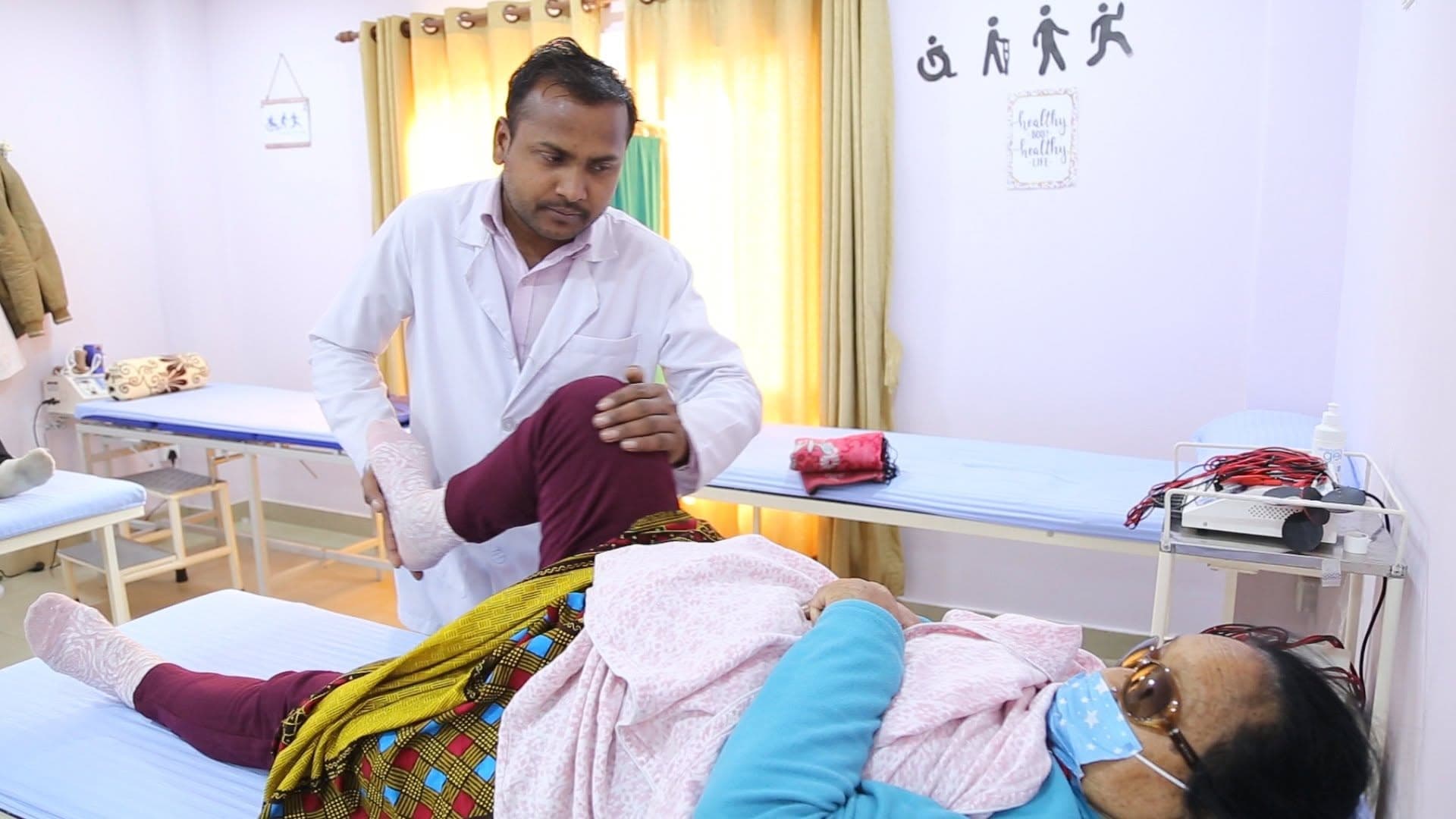 A Naman physiotherapist doing knee mobilisation with a resident in our treatment room