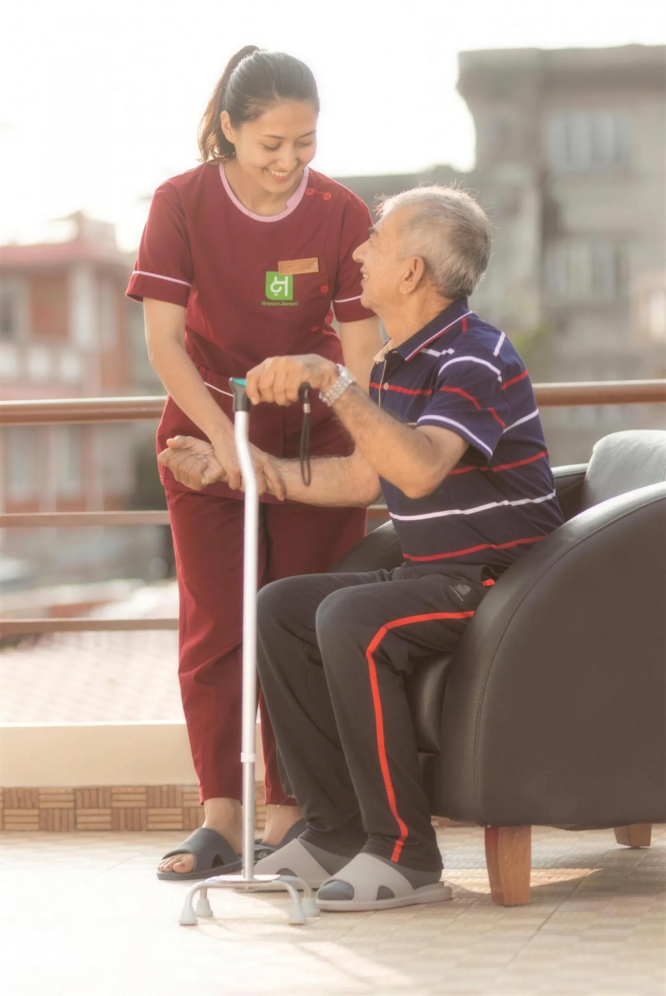 A caregiver assisting a resident on the rooftop terrace
